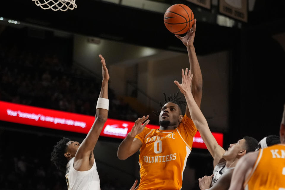 Tennessee forward Jonas Aidoo (0) shoots over Vanderbilt guard Tyrin Lawrence, left, and guard Jason Rivera-Torres, right, during the first half of an NCAA college basketball game Saturday, Jan. 27, 2024 in Nashville, Tenn. (AP Photo/George Walker IV)