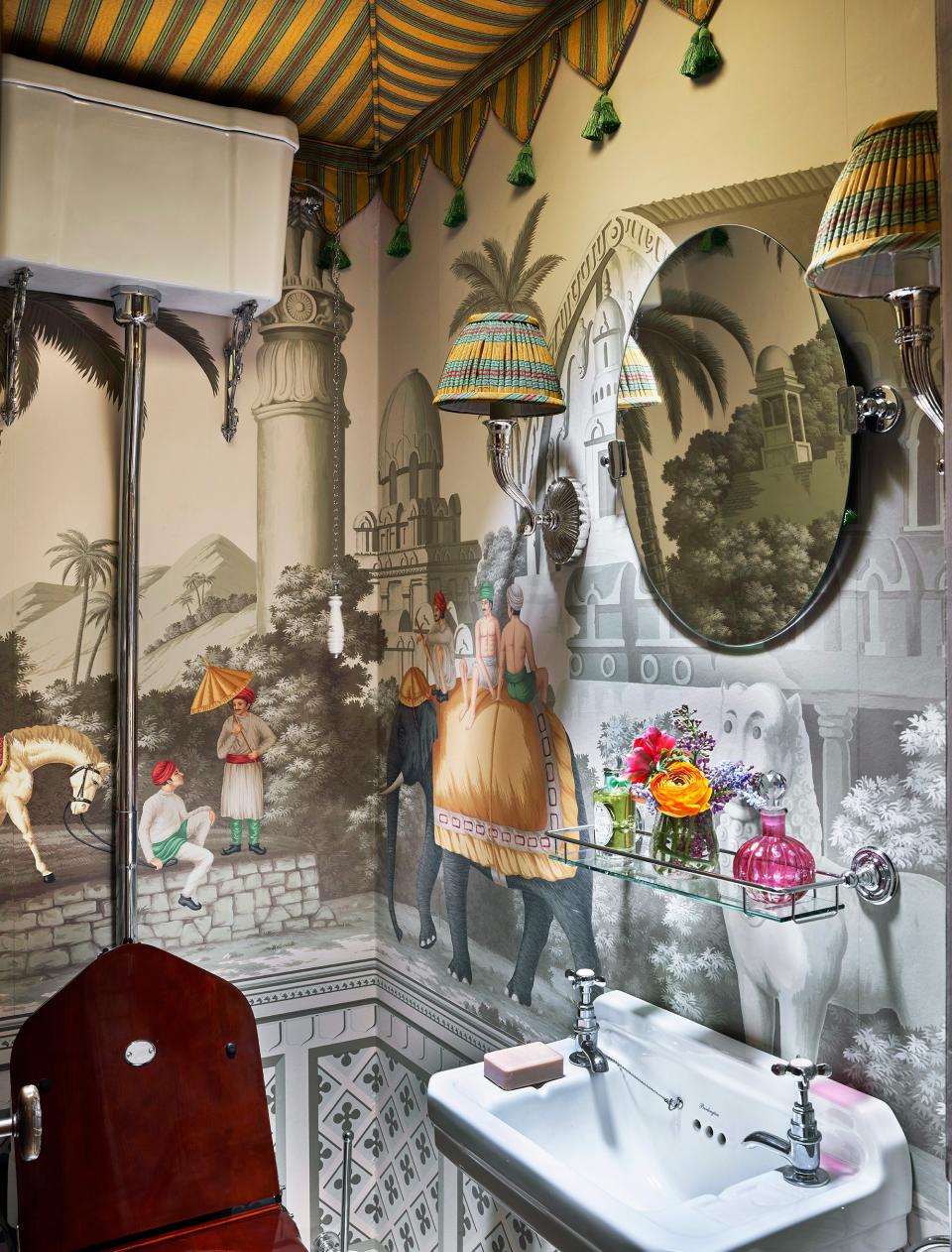 A moiré stripe tents a bath. Vaughan sconces; de Gournay wallpaper.