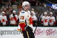 Calgary Flames center Sean Monahan (23) smiles after left wing Matthew Tkachuk (19) scores a goal during the second period of an NHL hockey game against the Dallas Stars, Sunday, Dec. 22, 2019, in Dallas. (AP Photo/Sam Hodde)