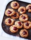 <p>Simple cookies sprinkled with walnuts and topped with jam are easy way to add festive color your holiday cookie spread.</p><p><em><a href="https://www.goodhousekeeping.com/food-recipes/a16189/jammy-thumbprints-recipe-ghk1214/" rel="nofollow noopener" target="_blank" data-ylk="slk:Get the recipe for Jammy Thumbprints »;elm:context_link;itc:0;sec:content-canvas" class="link ">Get the recipe for Jammy Thumbprints »</a></em></p>