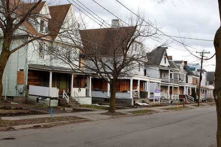 A row of vacant houses sits on Crandall Street, a street that became a hub for narcotics activity according to local media and police, in Binghamton, New York, U.S., April 8, 2018. REUTERS/Andrew Kelly