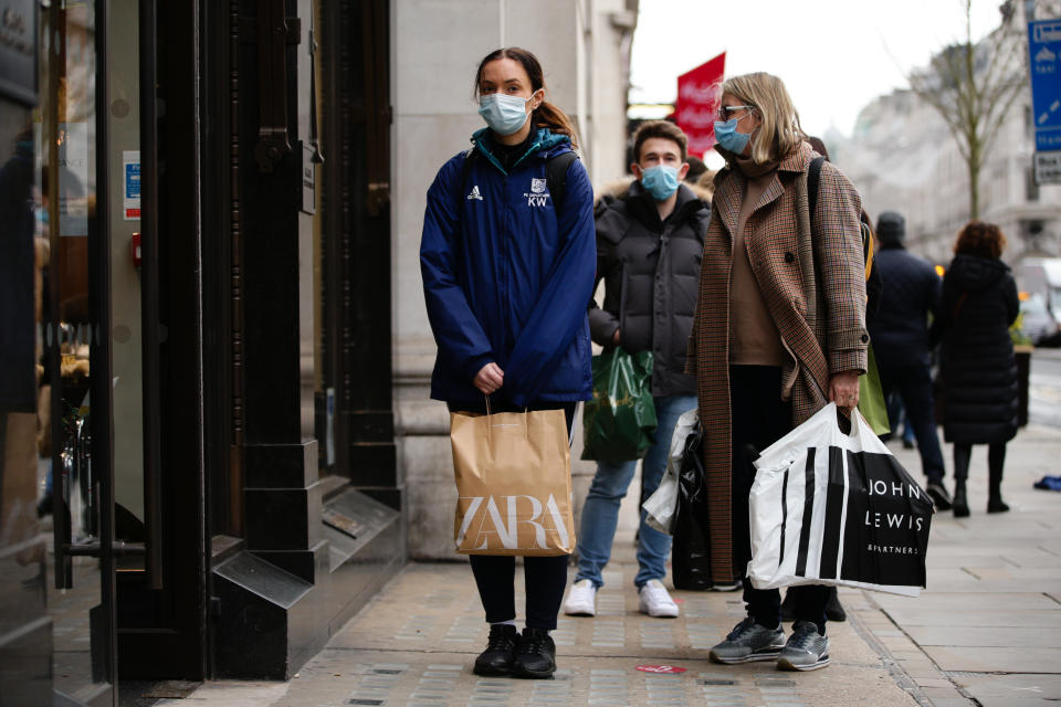 Shoppers wearing face masks queue to enter a homeware store on Regent Street in London, England, on December 4, 2020. London has returned to so-called Tier 2 or 'high alert' coronavirus restrictions since the end of the four-week, England-wide lockdown on Wednesday, meaning a reopening of non-essential shops and hospitality businesses as the festive season gets underway. Rules under all three of England's tiers have been strengthened from before the November lockdown, however, with pubs and restaurants most severely impacted. In London's West End, Oxford Street and Regent Street were both busy with Christmas shoppers this afternoon, meanwhile, with the retail sector hoping for a strong end to one of its most difficult years. (Photo by David Cliff/NurPhoto via Getty Images)