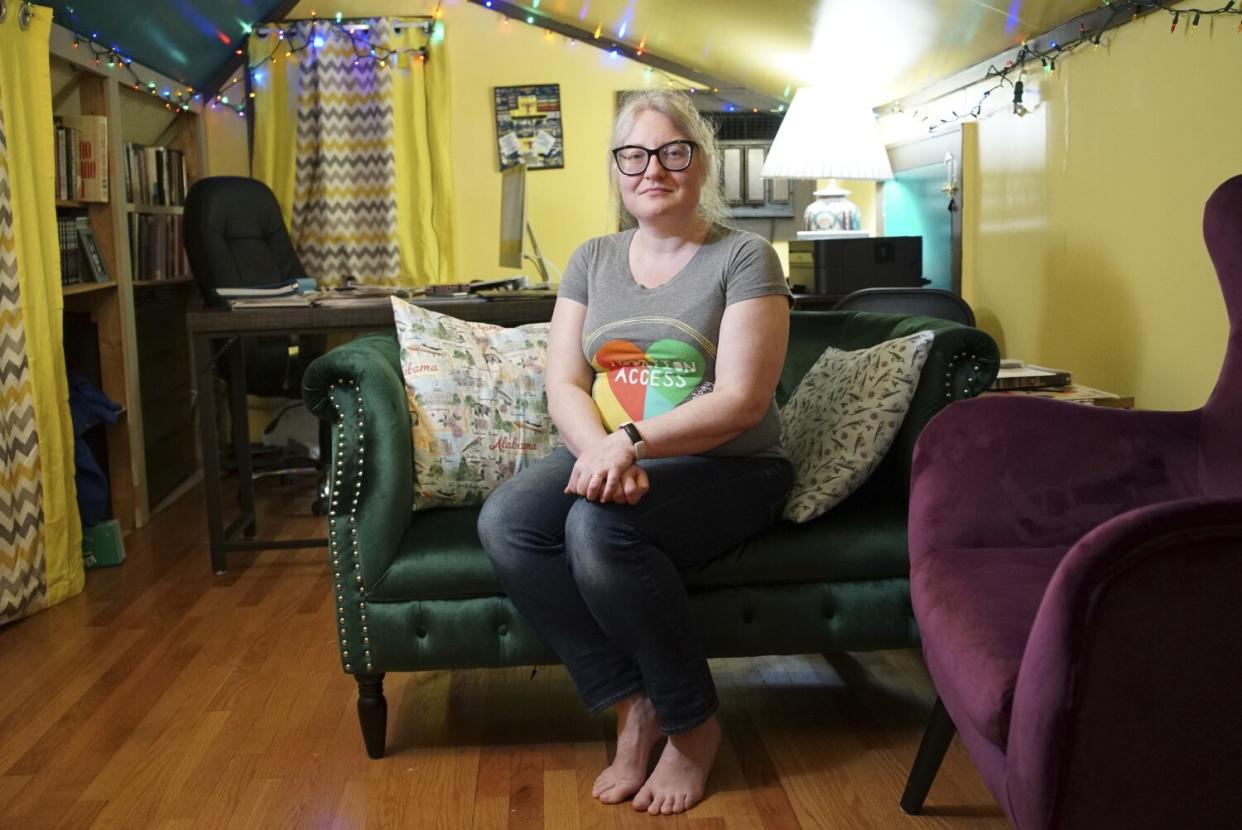 A woman seated on a couch.