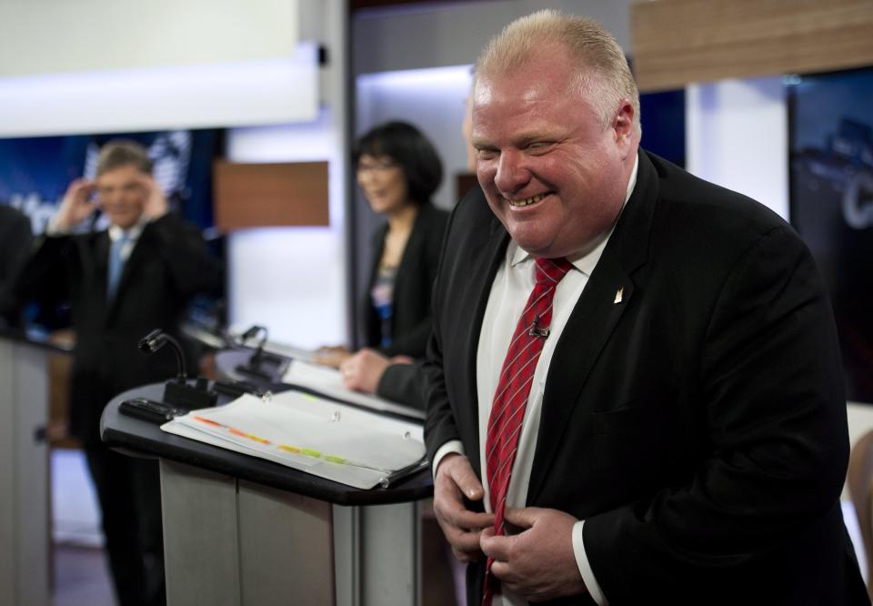 Mayor Rob Ford laughs during a commercial break as he takes part in a live television mayoral debate in Toronto on Wednesday, March 26, 2014. (AP Photo/The Canadian Press, Nathan Denette)