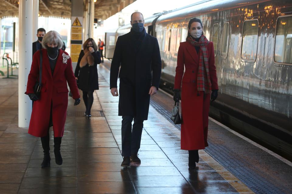 Britain's Prince William (C), Duke of Cambridge and Britain's Catherine (R), Duchess of Cambridge walk with Lord Lieutenant of South Glamorgan Morfudd Meredith (L) as they arrive at Cardiff Central train station in Cardiff, South Wales on December 8, 2020, on the final day of engagements on their tour of the UK. - During their trip, their Royal Highnesses hope to pay tribute to individuals, organisations and initiatives across the country that have gone above and beyond to support their local communities this year. (Photo by Geoff Caddick / various sources / AFP) (Photo by GEOFF CADDICK/AFP via Getty Images)