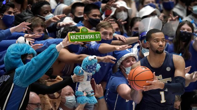Fans of Duke University reach out while Georgia Tech guard Kyle Sturdivant looks to put the ball inbound during the second half of an NCAA college basketball game in Durham, North Carolina, on Tuesday. (Photo: Gerry Broome/AP)