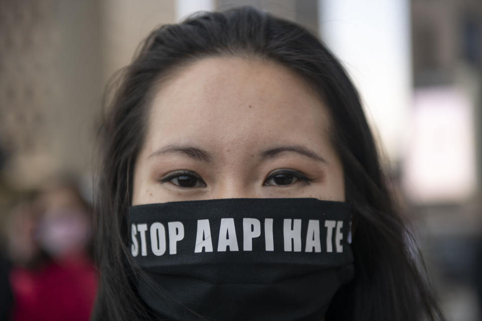 FILE - This March 27, 2021, file photo shows, Martha Bryan standing at Spirit Plaza after marching during the second consecutive weekend of Stop Asian Hate Protest in Detroit. A national coalition of civil rights groups will release on Wednesday, July 28, 2021, a comprehensive, state-by-state review of hate crime laws in the United States. Members of the coalition say the report sets the stage for bolstering the efficacy of current law and addresses racial disparities in how the laws are enforced. (Nicole Hester/Ann Arbor News via AP, File)