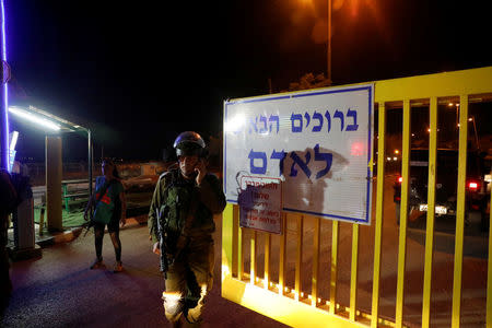 A security guard speaks on his mobile phone at the Israeli settlement Adam, after a Palestinian assailant stabbed three people and then was shot and killed, according to the Israeli military, in the occupied West Bank, July 26, 2018 REUTERS/Ronen Zvulun