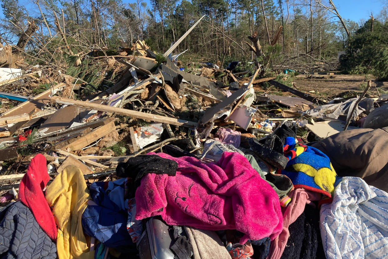 Debris is piled up following severe weather Wednesday, Dec. 14, 2022, in Keithville, La. A volatile storm ripping across the U.S. spawned tornadoes that killed a young boy and his mother in Louisiana, smashed mobile homes and chicken houses in Mississippi and threatened neighboring Southern states with more punishing weather Wednesday. (AP Photo/Jake Bleiberg)