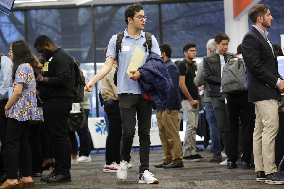 Georgia Tech student Sajad Abavisani, center, walks through the Startup Student Connection job fair, Wednesday, March 29, 2023, in Atlanta. For the thousands of workers who'd never experienced upheaval in the tech sector, the recent mass layoffs at companies like Google, Microsoft, Amazon and Meta came as a shock. Now they are being courted by long-established employers whose names aren't typically synonymous with tech work, including hotel chains, retailers, investment firms, railroad companies and even the Internal Revenue Service. (AP Photo/Alex Sliz)