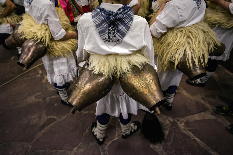 In this Monday, Jan. 27, 2020 photo, ''Joaldunaks'' wear cowbells hung across their lower back before taking part in a Carnival in the small Pyrenees village of Zubieta, northern Spain. In one of the most ancient carnival celebrations in Europe, dozens of people don sheepskins, lace petticoats and conical caps and sling cowbells across their lower backs as they parade to herald the advent of spring. (AP Photo/Alvaro Barrientos)