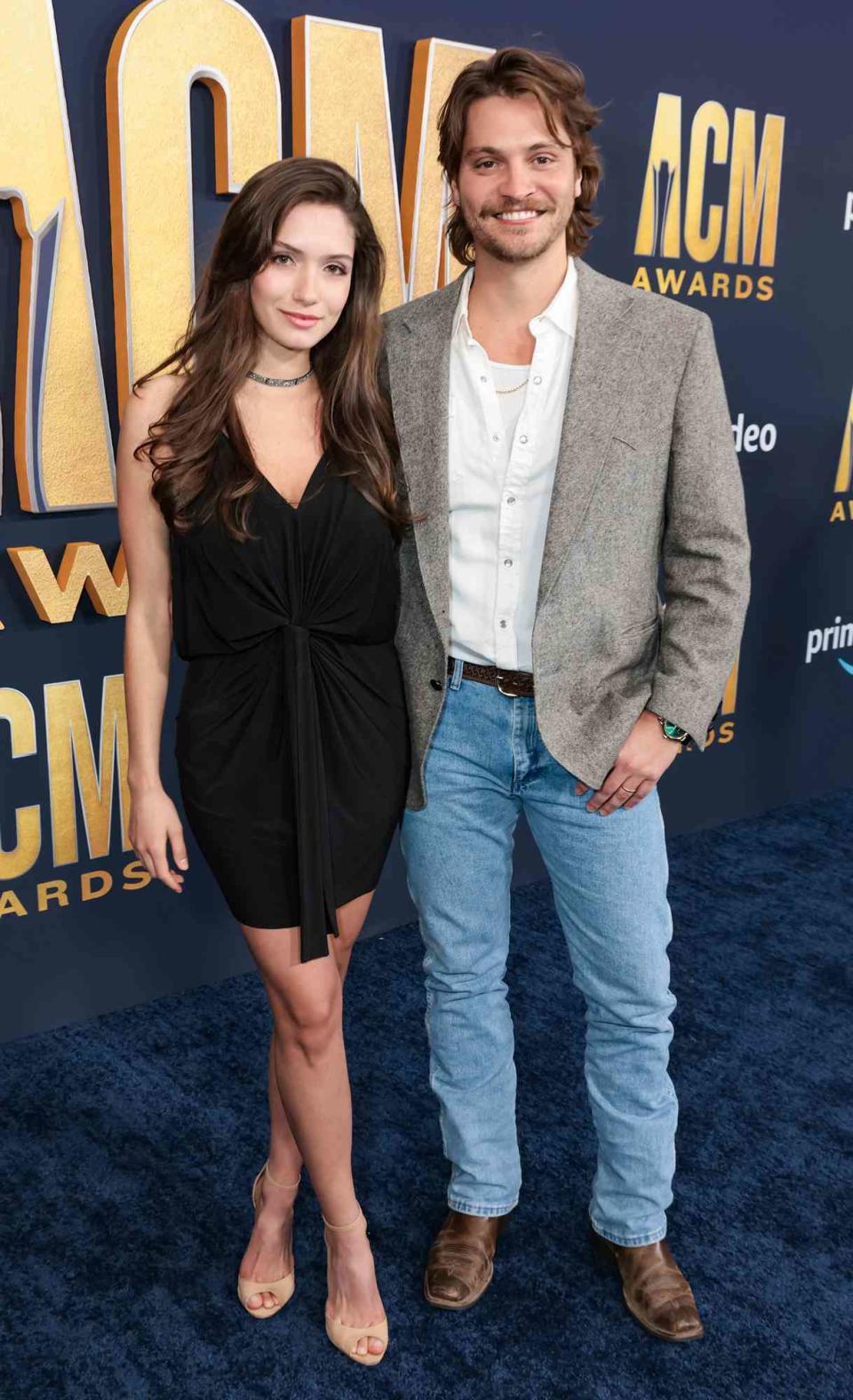 Luke Grimes (R) and Bianca Rodrigues attend the 57th Academy of Country Music Awards at Allegiant Stadium on March 07, 2022 in Las Vegas, Nevada