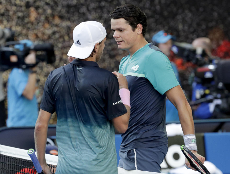 France's Lucas Pouille, left, is congratulated by Canada's Milos Raonic after winning their quarterfinal match at the Australian Open tennis championships in Melbourne, Australia, Wednesday, Jan. 23, 2019. (AP Photo/Aaron Favila)