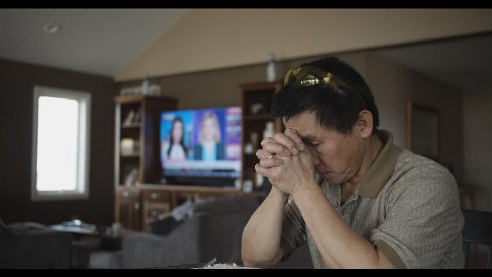 Michigan restaurant owner Chun Siev prays in the documentary film "Bad Axe" by his son David Siev. The film focuses on the family and their restaurant, Rachel's, in Bad Axe as they navigate the pandemic and a tumultuous 2020.