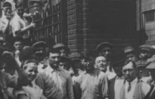 B.F. Goodrich workers stand at the gate in 1915 during the filming of the Akron movie  “The Portage Trail.”