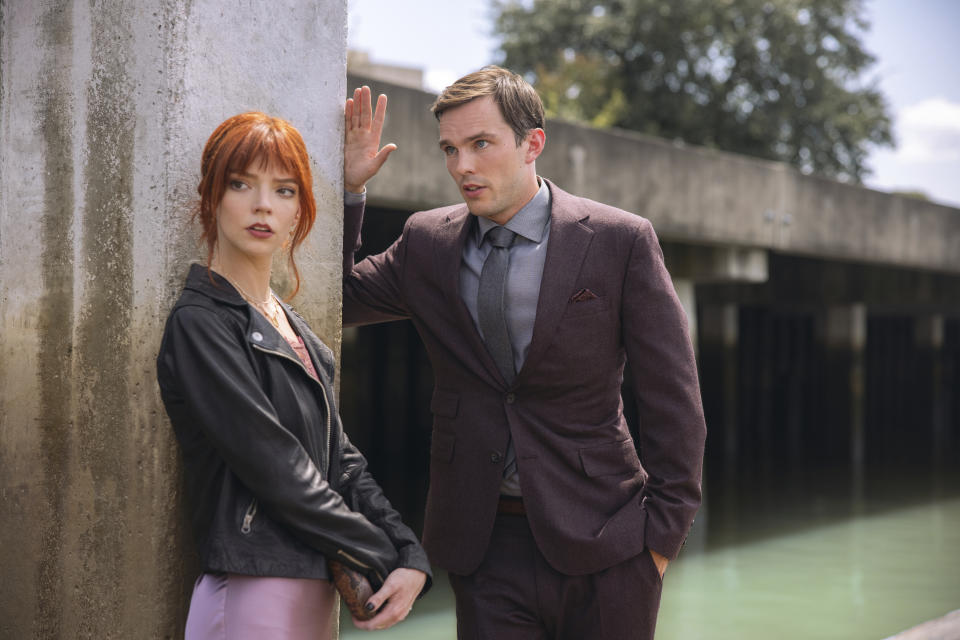 This image released by Searchlight Pictures shows Anya Taylor-Joy, left, and Nicholas Hoult in a scene from the film "The Menu." (Eric Zachanowich/Searchlight Pictures via AP)