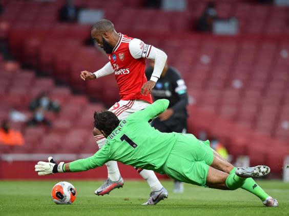 Alexandre Lacazette rounds Alisson Becker to score (Getty)