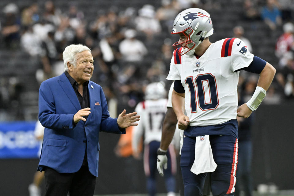 New England Patriots quarterback Mac Jones, right, talks with Patriots CEO Robert Kraft before an NFL football game against the Las Vegas Raiders, Sunday, Oct. 15, 2023, in Las Vegas. (AP Photo/David Becker)