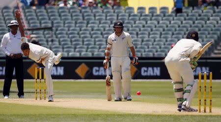 Australia's Mitchell Starc (2nd L) bowls the first delivery of the match to New Zealand's Martin Guptill during the first day of their third cricket test match at the Adelaide Oval, in South Australia, November 27, 2015. REUTERS/David Gray