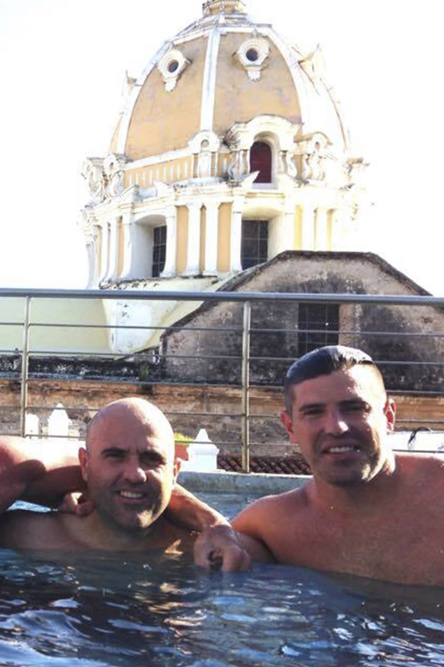 This October 2014 photo obtained by The Associated Press shows then-U.S. Drug Enforcement Administration Agents Jose Irizarry and George Zoumberos in a rooftop pool at a luxury hotel in Cartagena, Colombia, during a DEA assignment for "Operation Whitewash." Irizarry long considered Zoumberos a brother but in his interviews with investigators accused his former partner of a list of crimes. (AP Photo)
