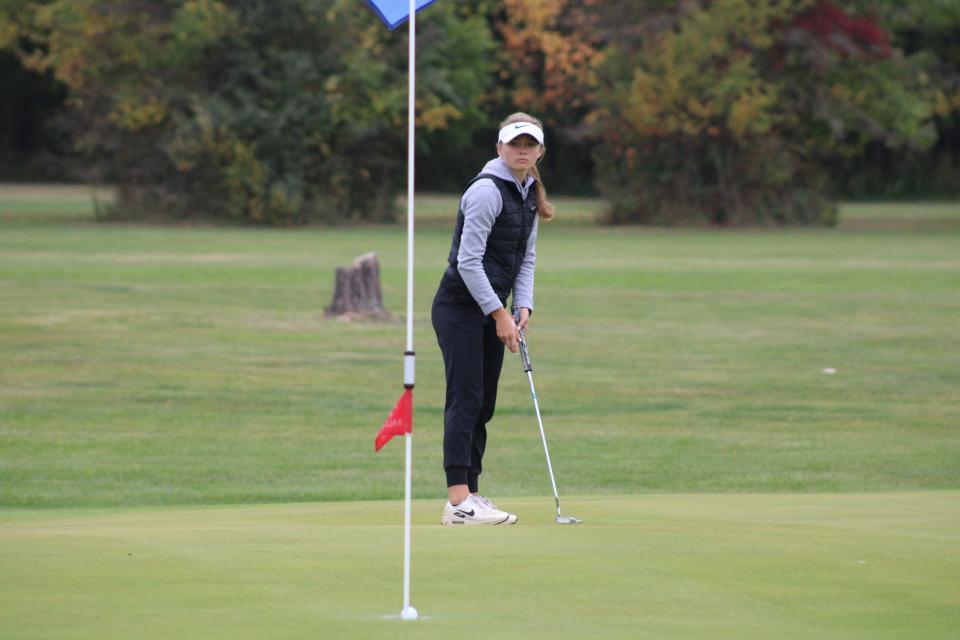 Tecumseh's Lucy Whelan watches her ball to the hole on a long putt Monday during the Lenawee County girls golf championship at Wolf Creek Golf Course in Adrian.