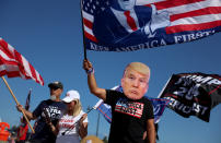 A Trumpist shows his support for former President Donald Trump in Palm Beach Florida. Trump called for backing from his supporters after he alleged on Twitter he was going to be arrested in a scheme due to his involvement with adult film actress Stormy Daniels