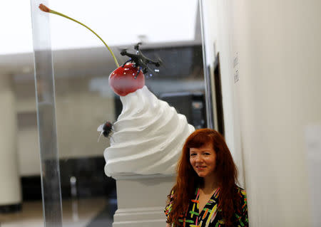 Artist Heather Phillipson stands beside a scale model of her sculpture 'THE END' at the National Gallery after it won the competition to become one of the pieces to be displayed on the fourth plinth in Trafalgar Square, in central London, Britain, March 21, 2017. REUTERS/Stefan Wermuth