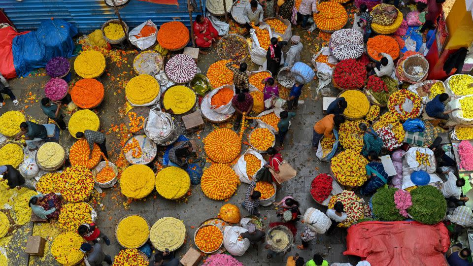 People visit a flower market on the eve of Diwali in Bangalore, India, on October 23, 2022. - Manjunath Kiran/AFP/Getty Images