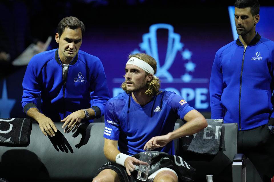 Europe's Stefanos Tsitsipas, center, talks to his teammate Roger Federer of Switzerland during a match on day one of the Laver Cup tennis tournament at the O2 in London, Friday, Sept. 23, 2022. (AP Photo/Kin Cheung)