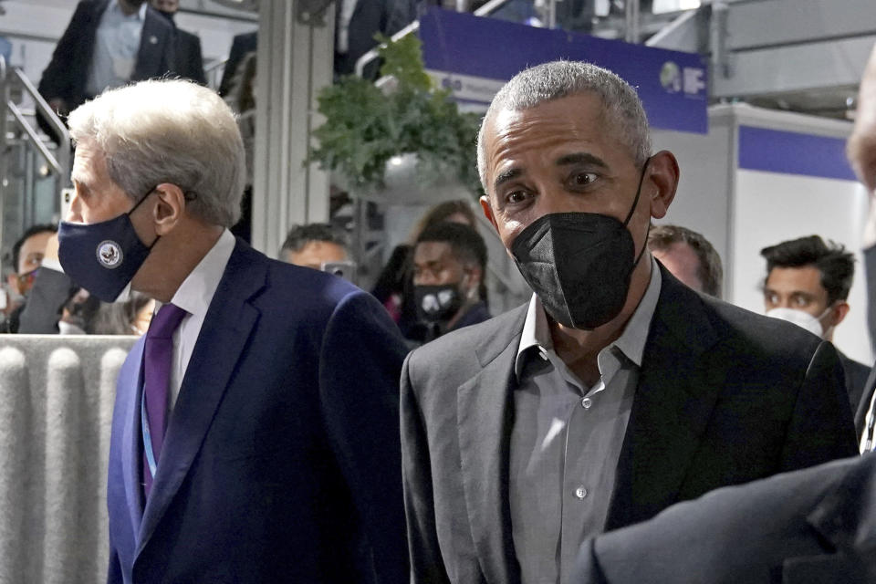 Former U.S. President Barack Obama is accompanied by John Kerry, United States Special Presidential Envoy for Climate, left, as he arrives at an event during the COP26 U.N. Climate Summit in Glasgow, Scotland, Monday, Nov. 8, 2021. The U.N. climate summit in Glasgow is entering it's second week as leaders from around the world, are gathering in Scotland's biggest city, to lay out their vision for addressing the common challenge of global warming. (Andrew Milligan/PA via AP)