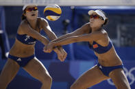 Xue Chen, right, of China, and teammate Wang Zinzin, close in on the ball during a women's beach volleyball match against the Netherlands at the 2020 Summer Olympics, Tuesday, July 27, 2021, in Tokyo, Japan. (AP Photo/Felipe Dana)