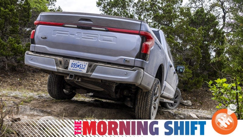 Ford press image of an F-150 Lightning on a gravel trail, viewed from the back