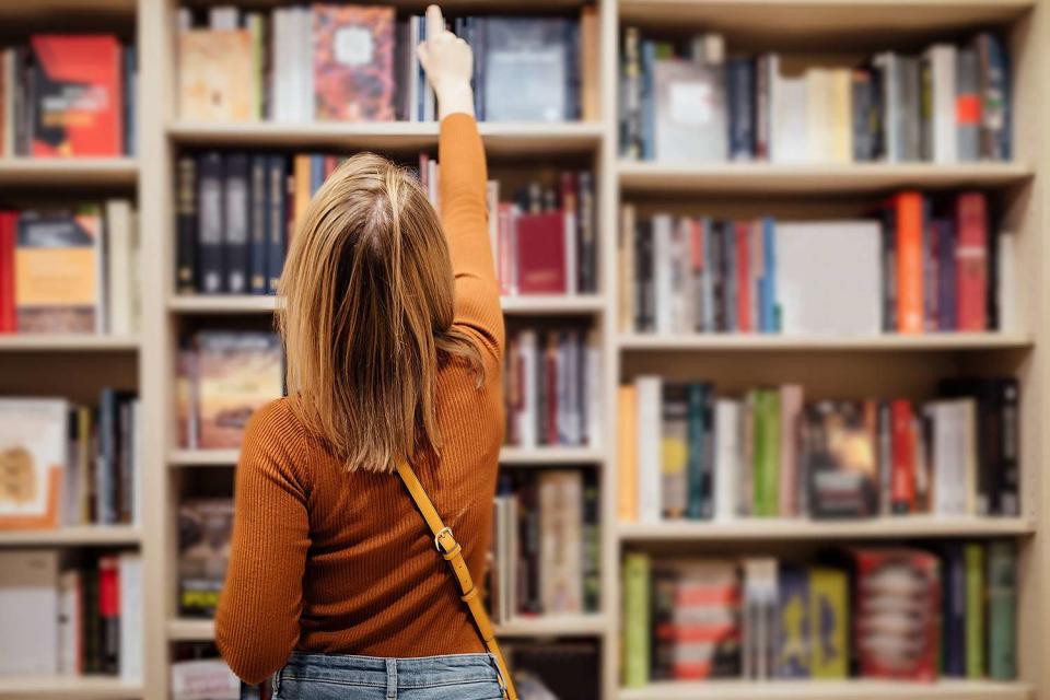 <p>Getty</p> A stock image of a person in a bookstore