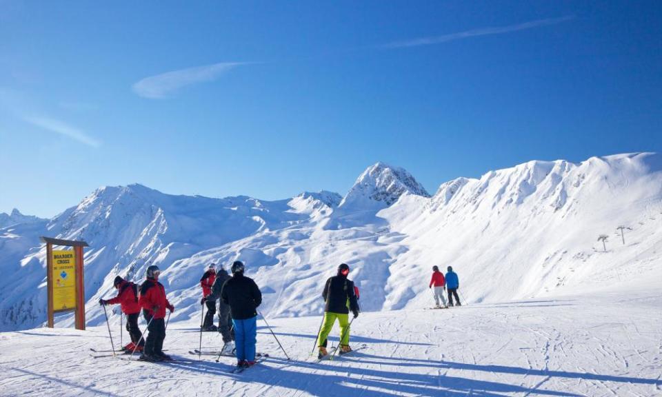 A group of skiers high up in the French Alps