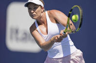 Danielle Collins returns a shot from Ons Jabeur of Tunisia, during the Miami Open tennis tournament, Monday, March 28, 2022, in Miami Gardens, Fla. (AP Photo/Wilfredo Lee)