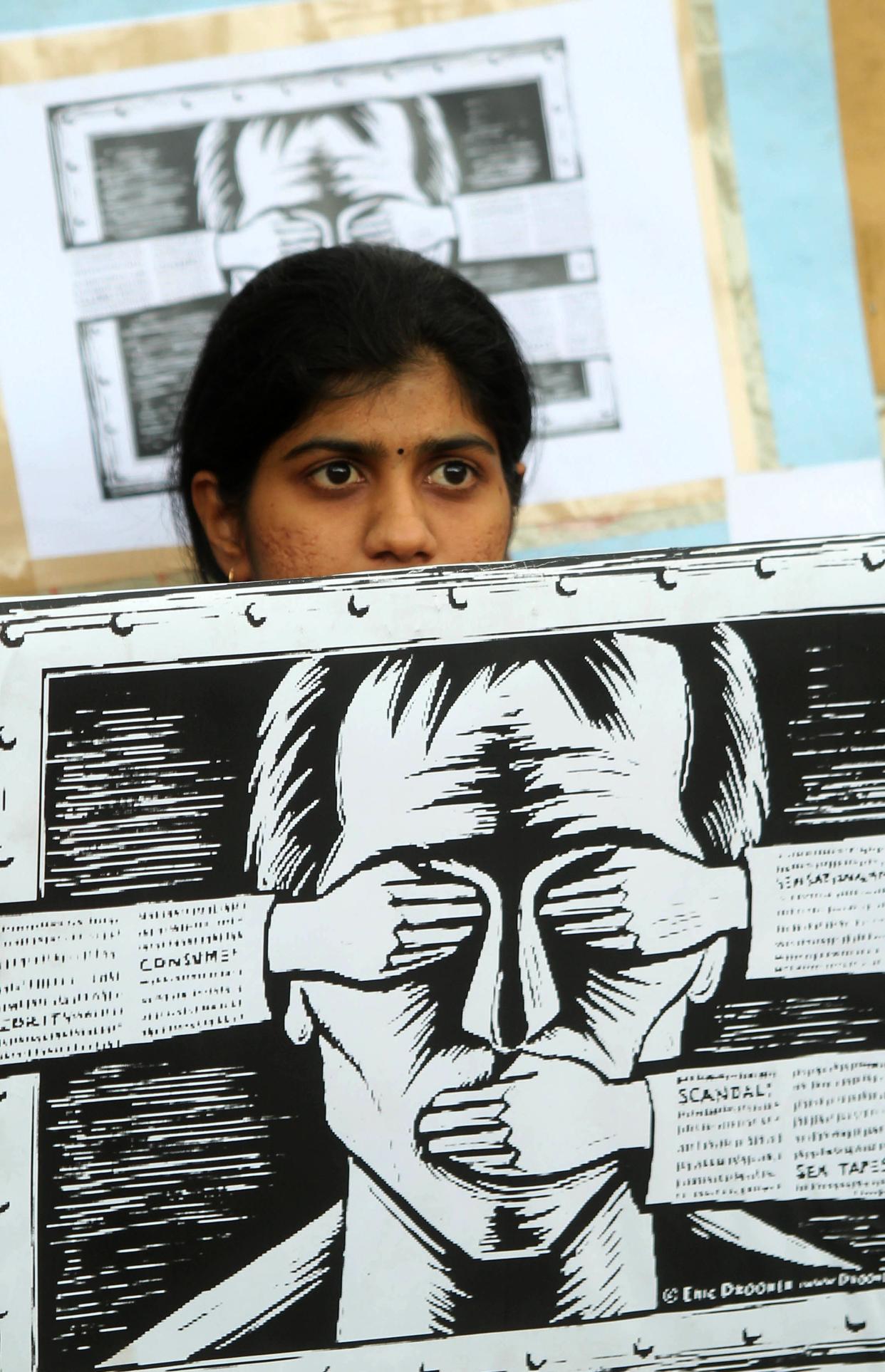 File image: An activist supporting the group Anonymous holds a poster as they protest against the Indian Government's increasingly restrictive regulation of the internet outside a shopping mall in Bangalore on June 9, 2012. (AFP via Getty Images)