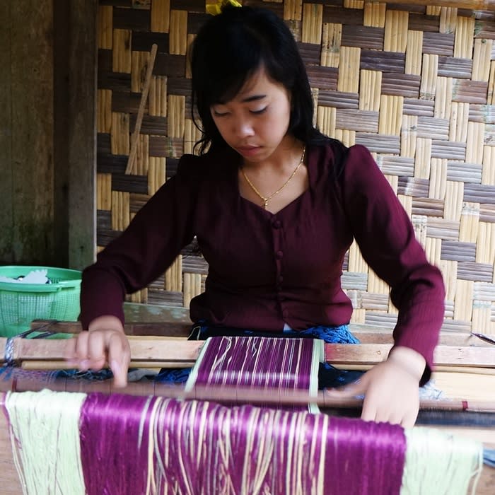 Woven-making: A Baduy Luar woman showing one of the traditional woven fabrics that she had made. The women weave and make their own fabric in the evening. (