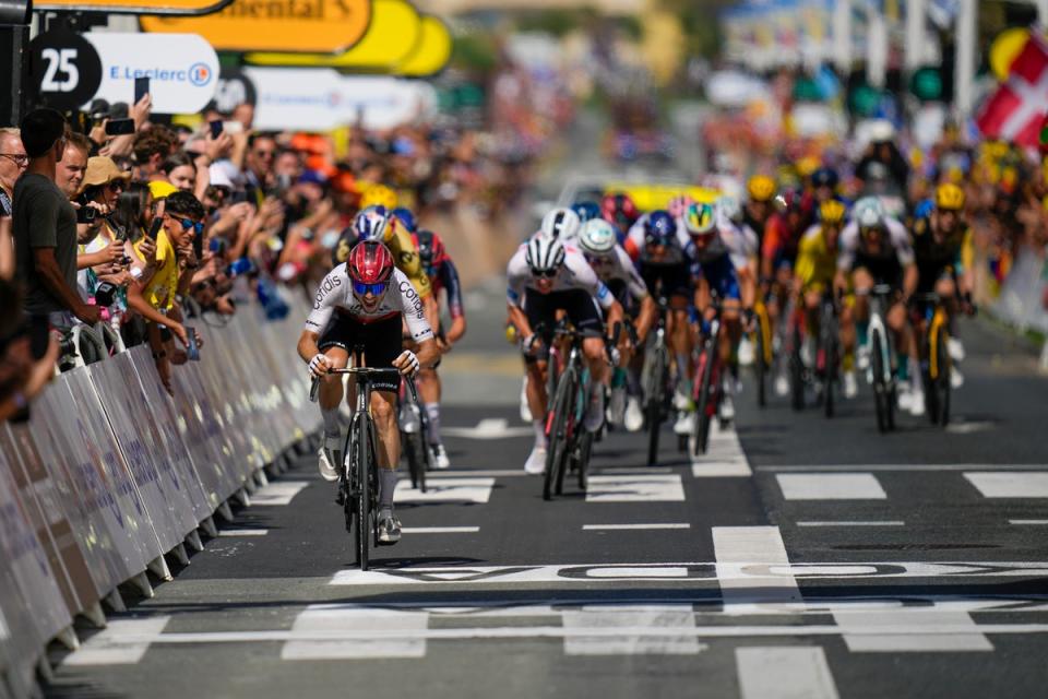 Victor Lafay crosses the finish line in front of the chasing peloton (AP)