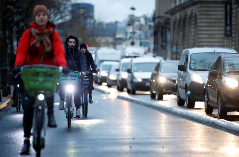 People ride bicycles as a strike by all unions of the Paris transport network (RATP) and French SNCF workers entered its seventh consecutive day in Paris