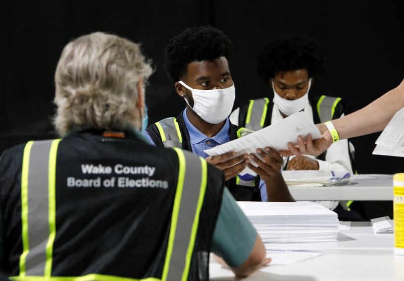 FILE PHOTO: FILE PHOTO: FILE PHOTO: Poll workers prepare absentee ballots for the general election in Raleigh