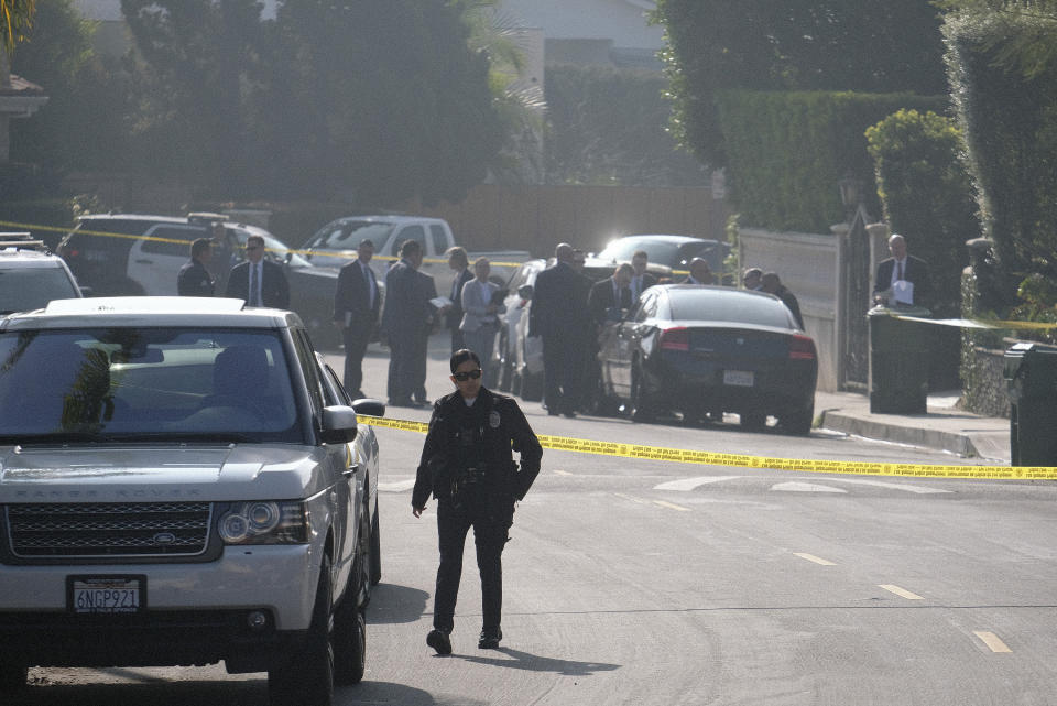 Police officers and investigators work outside a Hollywood Hills home where a fatal shooting occurred on Wednesday, Feb. 19, 2020, in Los Angeles. (AP Photo/Ringo H.W. Chiu)