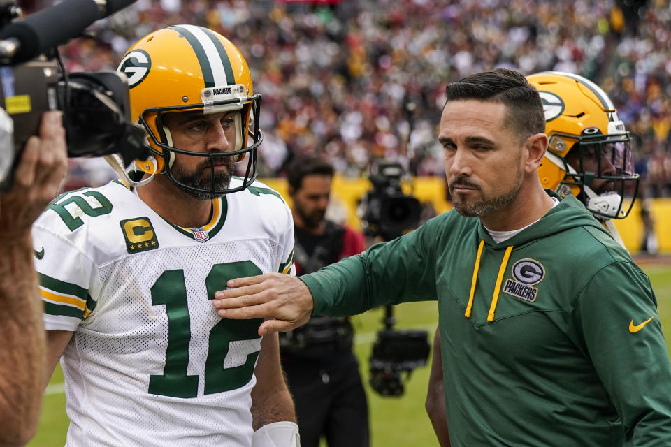 Green Bay Packers quarterback Aaron Rodgers (12) and head coach Matt LaFleur react during the second half of an NFL football game against the Washington Commanders, Sunday, Oct. 23, 2022, in Landover, Md. (AP Photo/Al Drago)