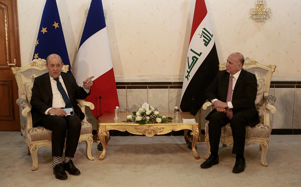 Iraqi Foreign Minister Fouad Hussein, right, meets with visiting French counterpart Jean-Yves Le Drian, in Baghdad, Iraq, Thursday, July 16, 2020. (AP Photo/Hadi Mizban)