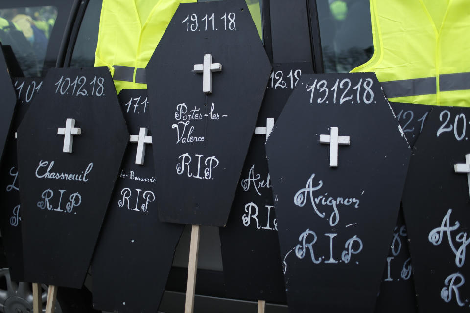 Yellow vest ptotesters display coffins to honor hundreds injured since the movement kicked off Nov. 17, Saturday, Jan. 19, 2019 in Paris. Ten people have been killed in protest-related traffic accidents. Yellow vest protesters are planning rallies in several French cities despite a national debate launched this week by President Emmanuel Macron aimed at assuaging their anger. (AP Photo/Thibault Camus)