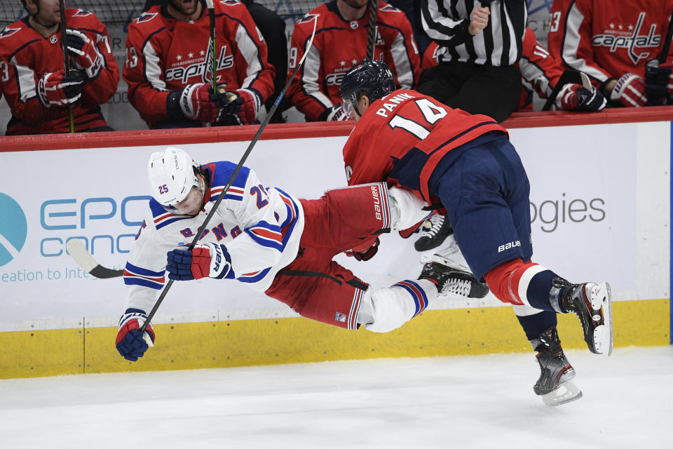 Washington Capitals right wing Richard Panik (14) collides with New York Rangers defenseman Libor Hajek (25) during the third period of an NHL hockey game, Sunday, March 28, 2021, in Washington. (AP Photo/Nick Wass)