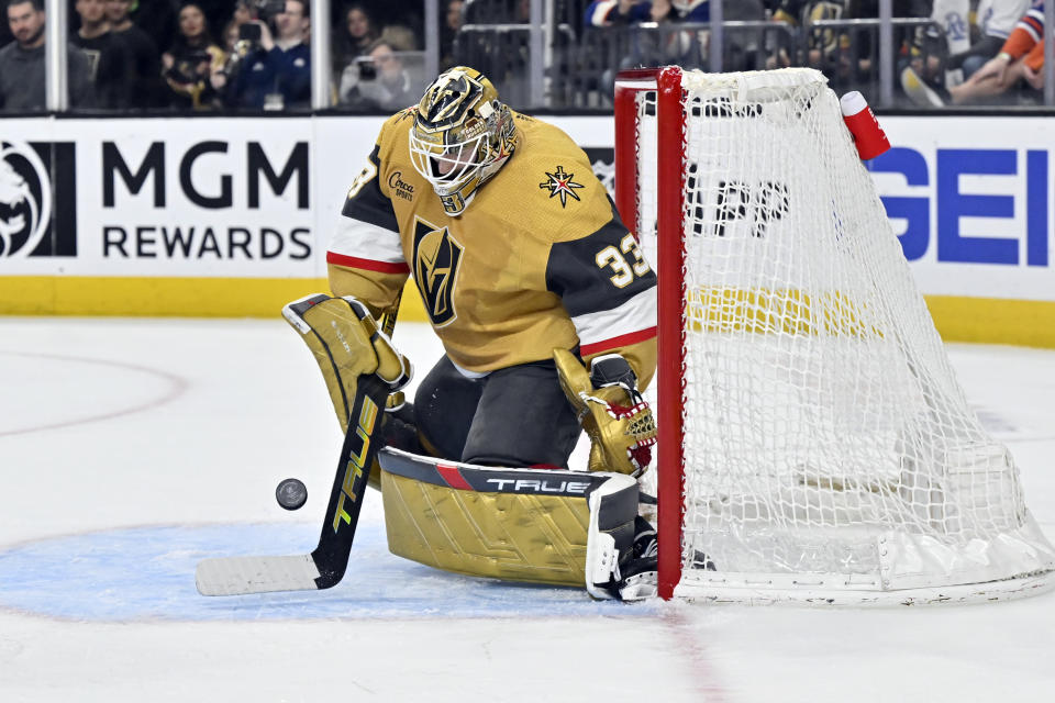 Vegas Golden Knights goaltender Adin Hill (33) stops the puck during the third period of the team's NHL hockey game against the Edmonton Oilers on Tuesday, Feb. 6, 2024, in Las Vegas. (AP Photo/David Becker)