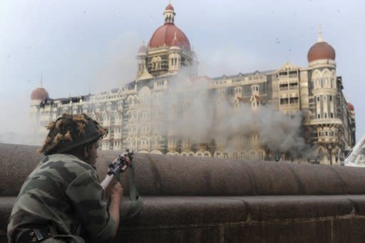 An Indian soldier takes shelter during the attack on the Taj Mahal Hotel in Mumbai in November 2008. Pakistan rejected Thursday renewed Indian charges that Pakistani "state actors" were involved in planning and coordinating the 2008 Mumbai attacks that left 166 people dead