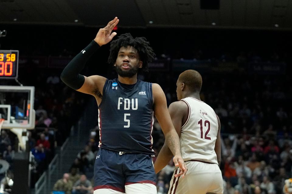 Fairleigh Dickinson's Ansley Almonor (5) celebrates after hitting a 3-point shot against Texas Southern's Zytarious Mortle (12) during the second half of a First Four college basketball game in the NCAA men's basketball tournament, Wednesday, March 15, 2023, in Dayton, Ohio. (AP Photo/Darron Cummings)