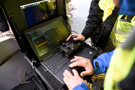 Volunteers of Israeli rescue and recovery organisation ZAKA survey images transmitted by an underwater sonar during a search for the remains of Holocaust victims murdered on the banks of the Danube river in 1944 in Budapest, Hungary January 15, 2019. REUTERS/Tamas Kaszas