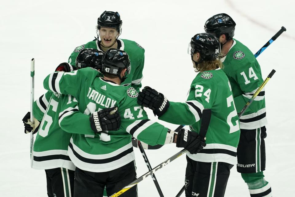 Dallas Stars' John Klingberg (3), Joe Pavelski (16), Roope Hintz (24) and Jamie Benn (14) celebrate with Alexander Radulov (47) following his goal in the second period of an NHL hockey game against the Nashville Predators in Dallas, Friday, Jan. 22, 2021. (AP Photo/Tony Gutierrez)